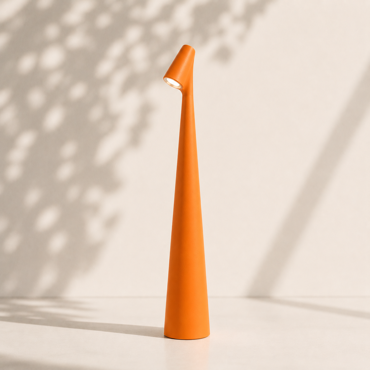 Orange cone-shaped object on a light background with shadows